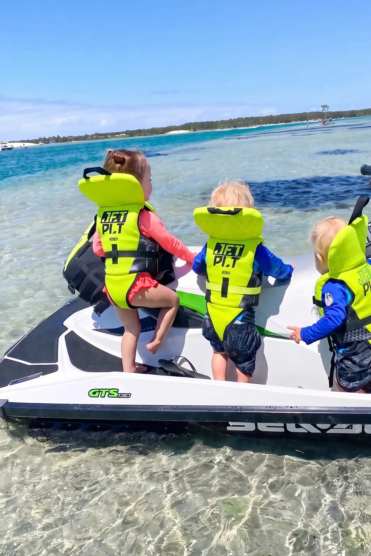 Children wearing Jetpilot Cause life jackets on a jet ski