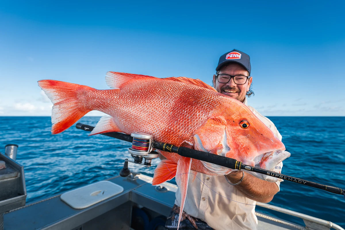 Angler with a red emperor caught on a Penn Supremacy overhead rod