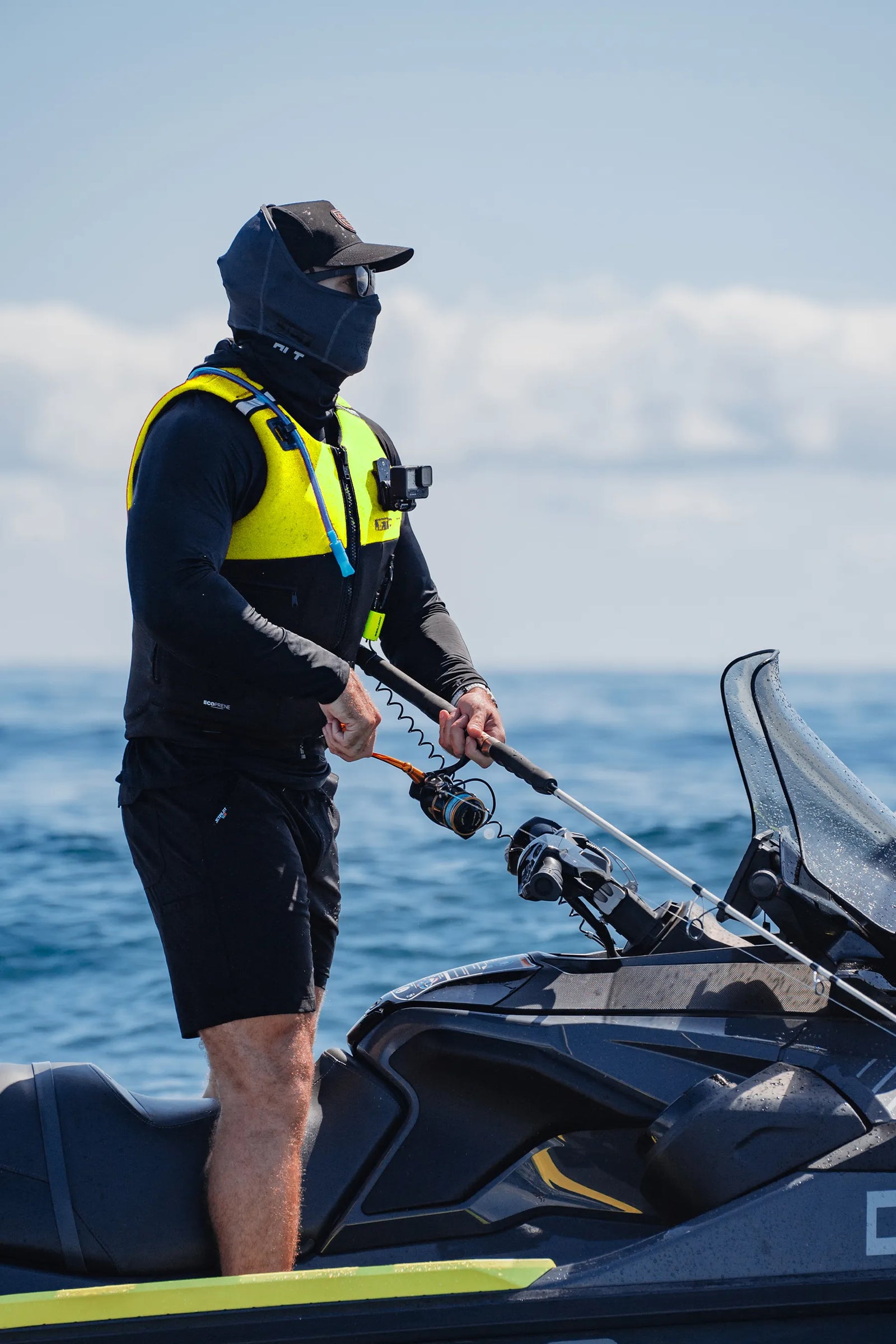 Rider fishing from a jet ski wearing the Jetpilot Venture life jacket
